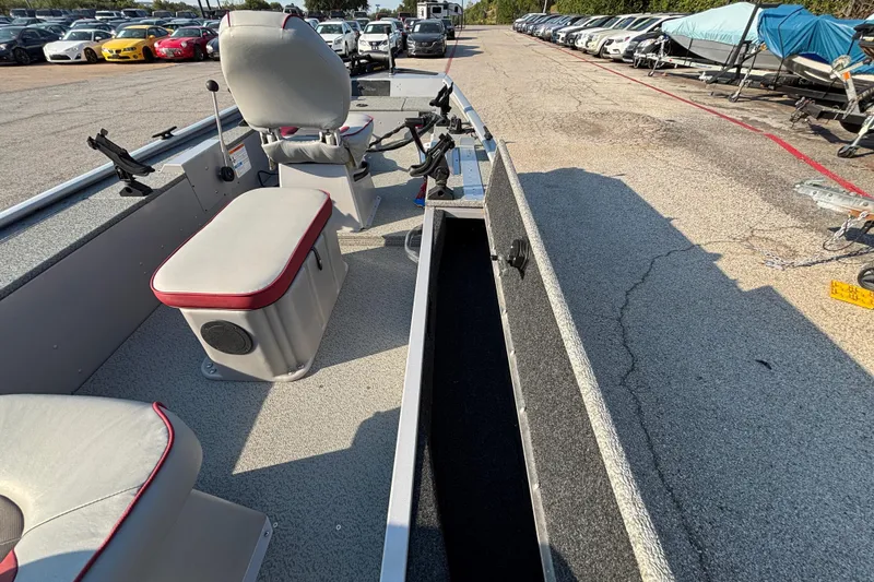 Slide: The Image of 2017 G3 Eagle 170 PFX boat interior with seating and storage, parked in a lot. - 33