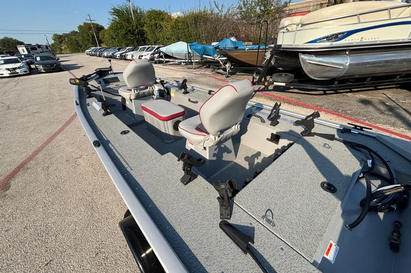 Slide: The Image of 2017 G3 Eagle 170 PFX fishing boat with seating, parked among other boats and vehicles. - 40