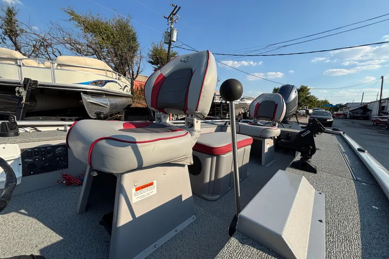 Slide: The Image of 2017 G3 Eagle 170 PFX boat interior with gray and red seating, outdoor setting. - 43