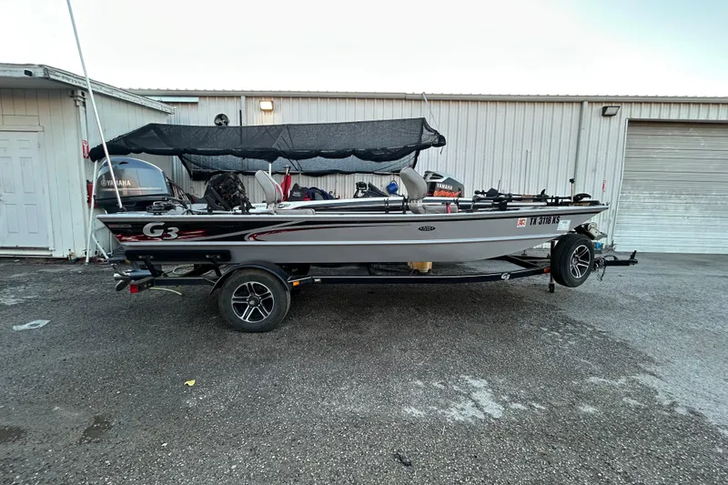 Slide: The Image of 2017 G3 Eagle 170 PFX boat with motor, parked in a lot with cars. - 5