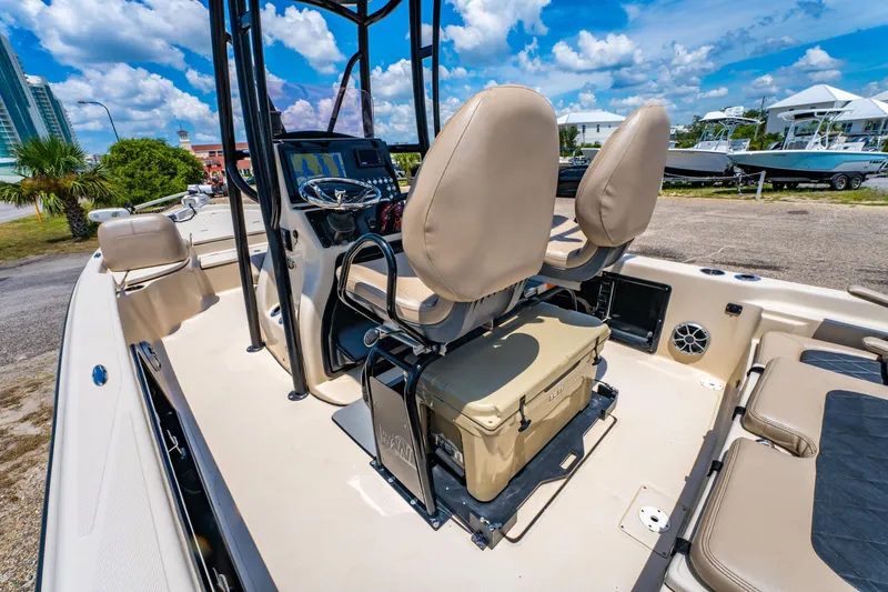 Slide: The Image of 2020 Blue Wave 2400 PureBay boat interior with beige seating and modern console. - 18