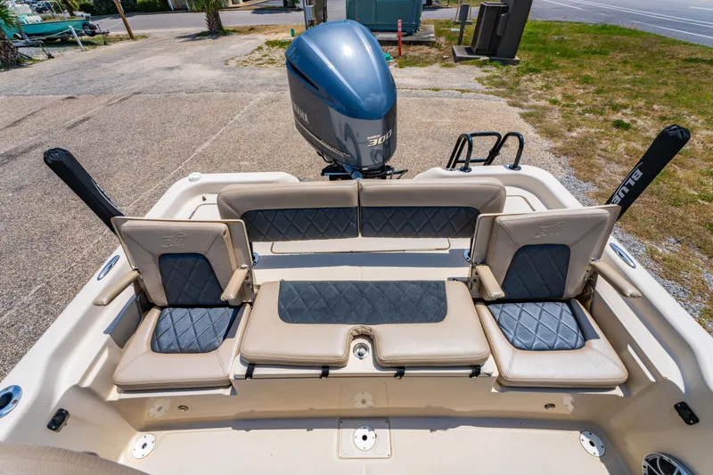 Slide: The Image of 2020 Blue Wave 2400 PureBay boat with cushioned seating and Yamaha engine. - 19