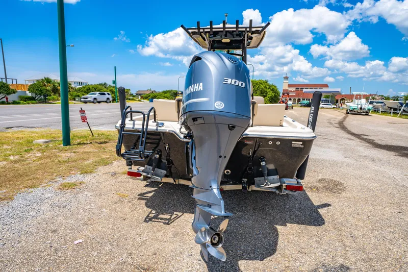 Slide: The Image of 2020 Blue Wave 2400 PureBay boat with Yamaha 300 engine, parked outdoors under blue sky. - 6