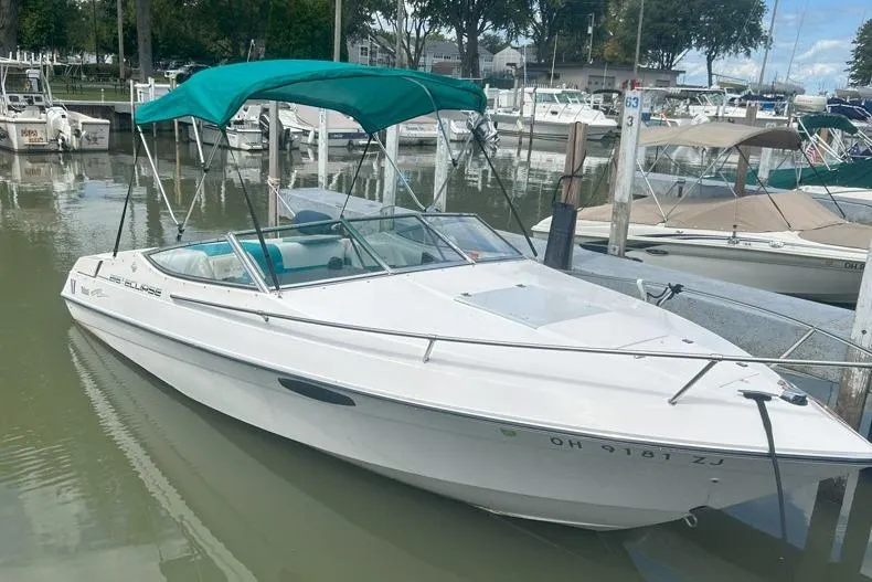 The Image of 1991 Wellcraft 216 Eclipse boat docked with green canopy in a marina. - 0