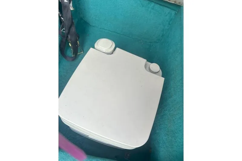 Slide: The Image of Portable toilet in 1991 Wellcraft 216 Eclipse boat with teal interior. - 10