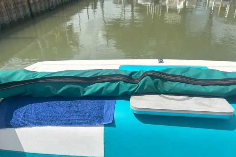 Slide: The Image of 1991 Wellcraft 216 Eclipse boat with blue towel and green cover on deck. - 7