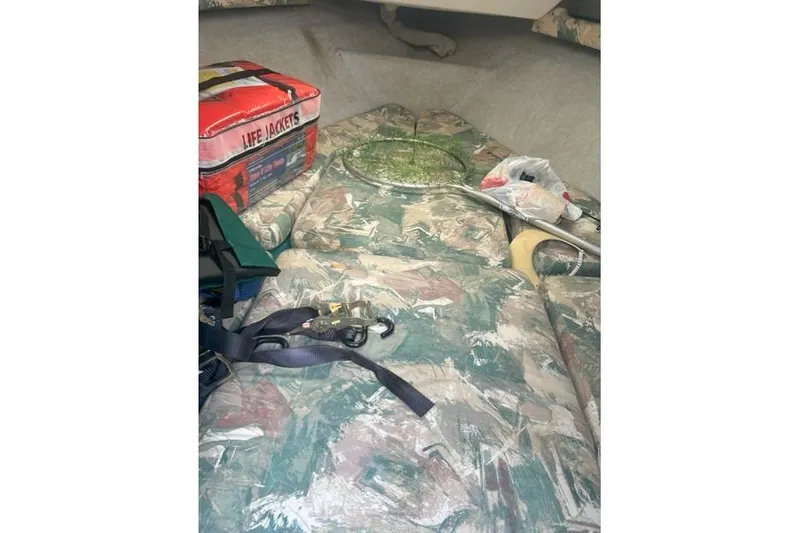 Slide: The Image of Interior of 1991 Wellcraft 216 Eclipse boat with life jackets and fishing gear. - 9