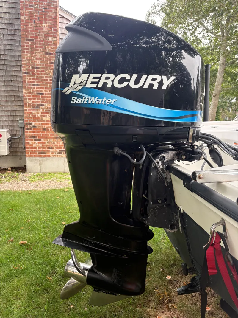 Slide: The Image of Mercury SaltWater outboard motor on a 2004 Boston Whaler 220 Dauntless boat. - 13