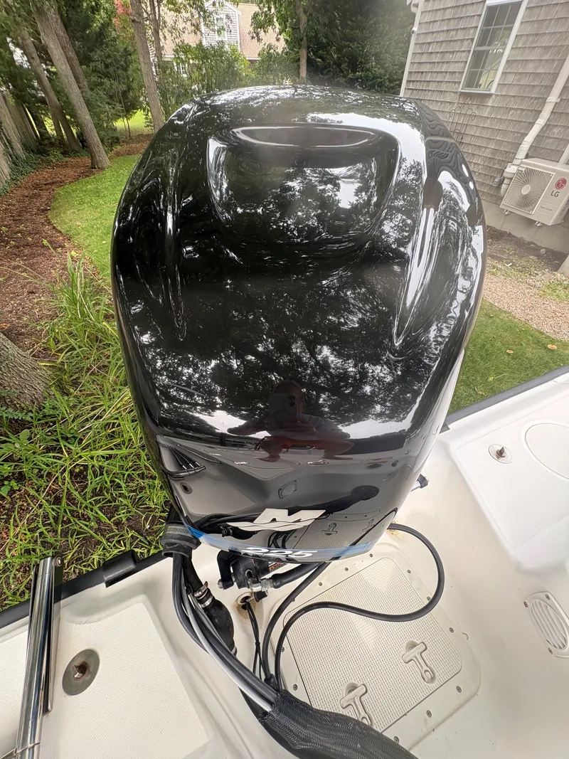 Slide: The Image of 2004 Boston Whaler 220 Dauntless boat engine, glossy black finish, outdoor setting. - 14