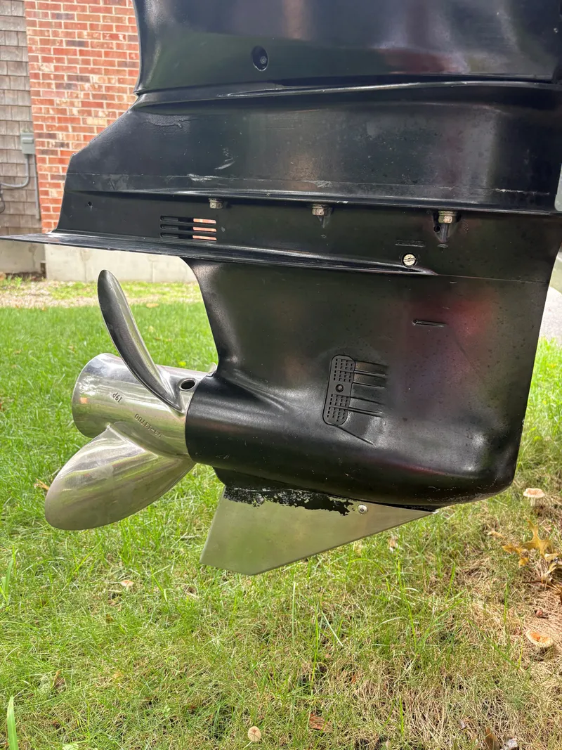 Slide: The Image of Close-up of a 2004 Boston Whaler 220 Dauntless boat propeller on grass. - 15