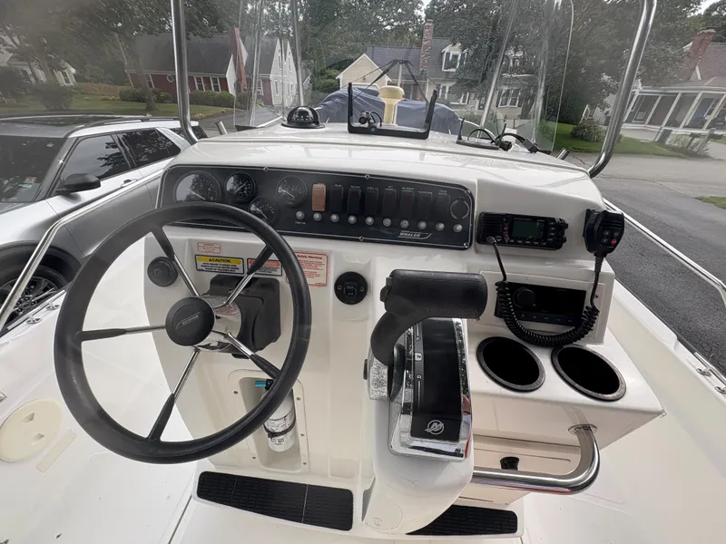 Slide: The Image of Boston Whaler 220 Dauntless 2004 boat console with steering wheel and controls. - 2