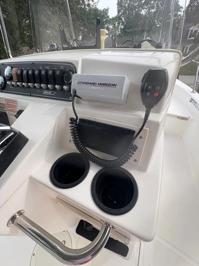 Slide: The Image of Control panel of a 2004 Boston Whaler 220 Dauntless boat with radio and cup holders. - 4