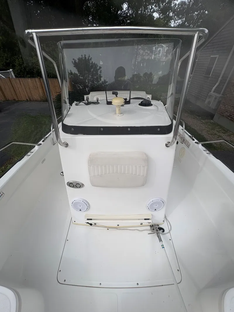 Slide: The Image of 2004 Boston Whaler 220 Dauntless boat interior with console and steering wheel. - 5