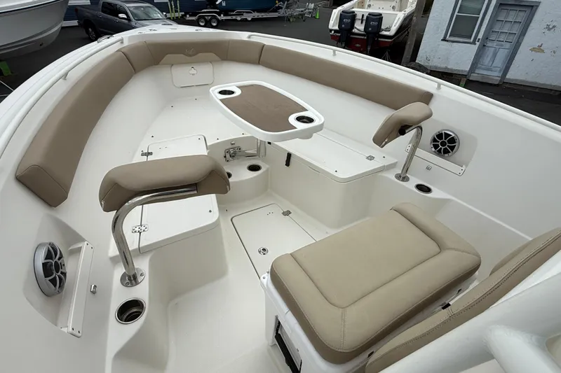 Slide: The Image of 2019 Sailfish 270 CC boat interior with beige seating and table, featuring modern design. - 13