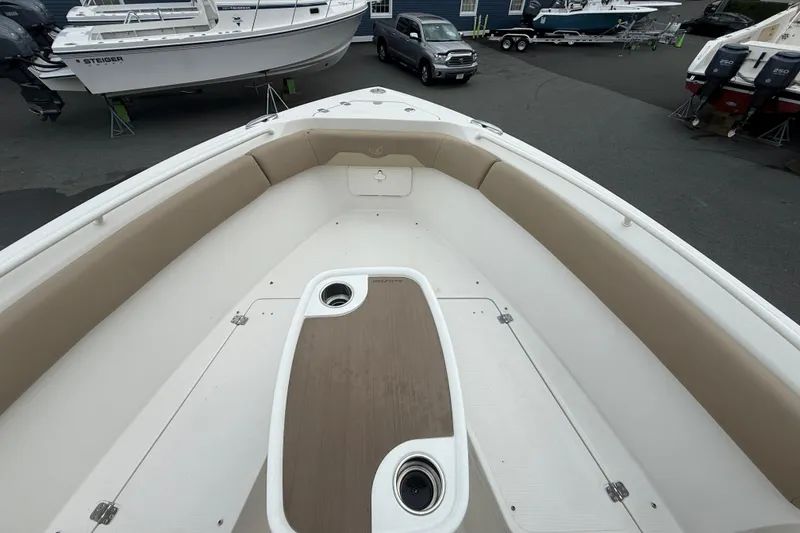 Slide: The Image of 2019 Sailfish 270 CC boat interior with cushioned seating and storage compartments. - 16