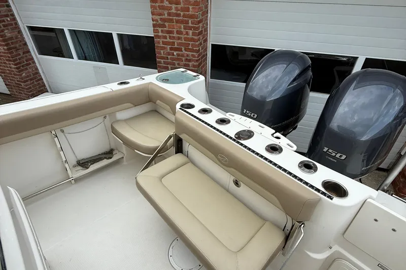 Slide: The Image of 2019 Sailfish 270 CC boat interior with seating and dual Yamaha 150 engines. - 18