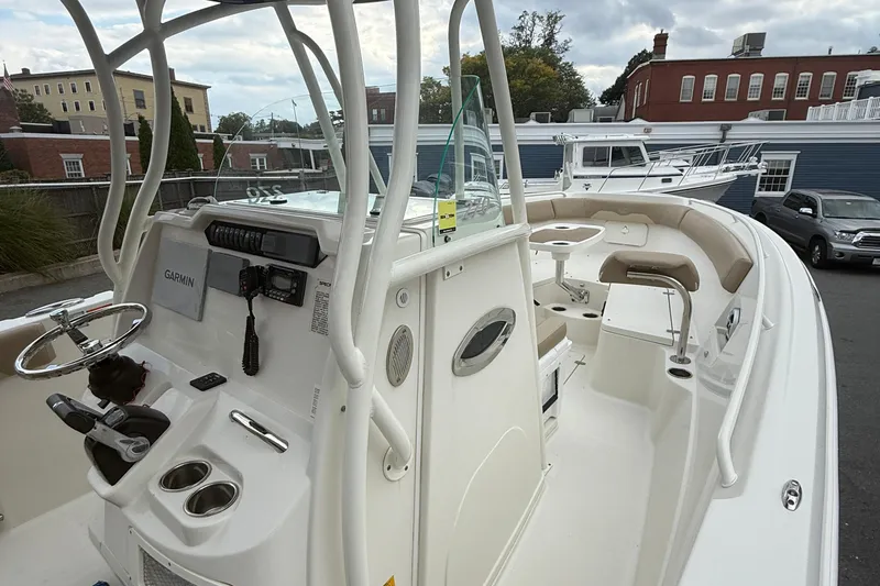 Slide: The Image of 2019 Sailfish 270 CC boat interior with steering console and seating area. - 21