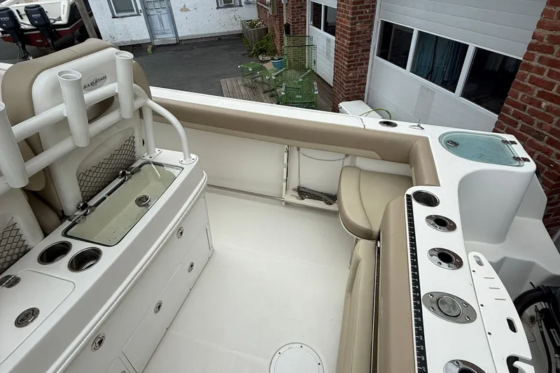 Slide: The Image of 2019 Sailfish 270 CC boat interior with seating and fishing rod holders. - 6