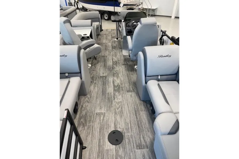 Slide: The Image of Interior of 2026 Bentley Pontoons Legacy 223 Navigator with gray seating and wood-style flooring. - 24