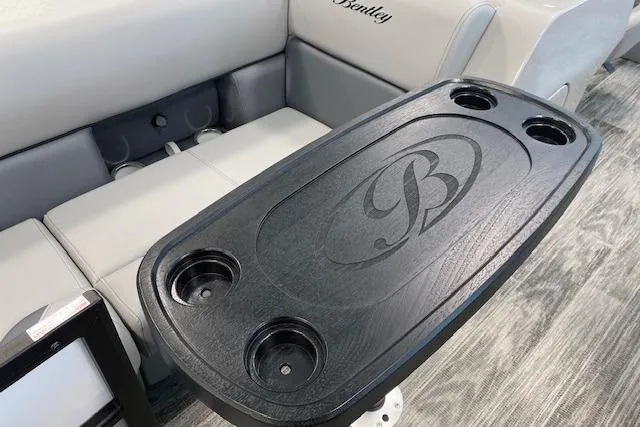 Slide: The Image of 2026 Bentley Pontoons Legacy 223 Navigator interior with cup holders and logo detail. - 6