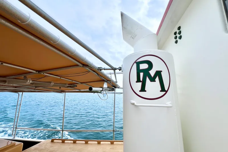 Slide: The Image of 1972 Mills Boat Works Tug Boat on water, featuring RM logo and canopy. - 14