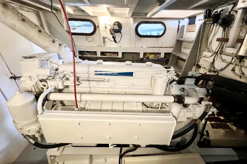 Slide: The Image of 1972 Mills Boat Works Tug Boat engine room with visible machinery and portholes. - 23