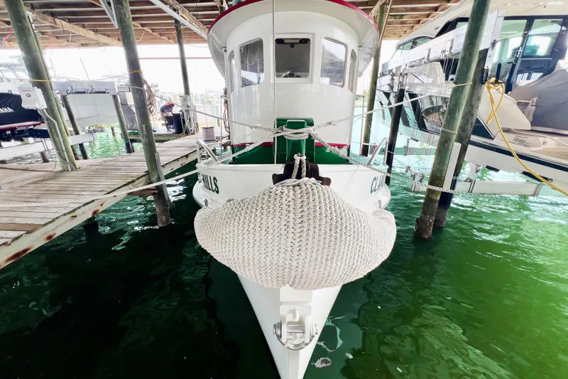 Slide: The Image of 1972 Mills Boat Works Tug Boat docked in marina, front view with rope fender. - 8