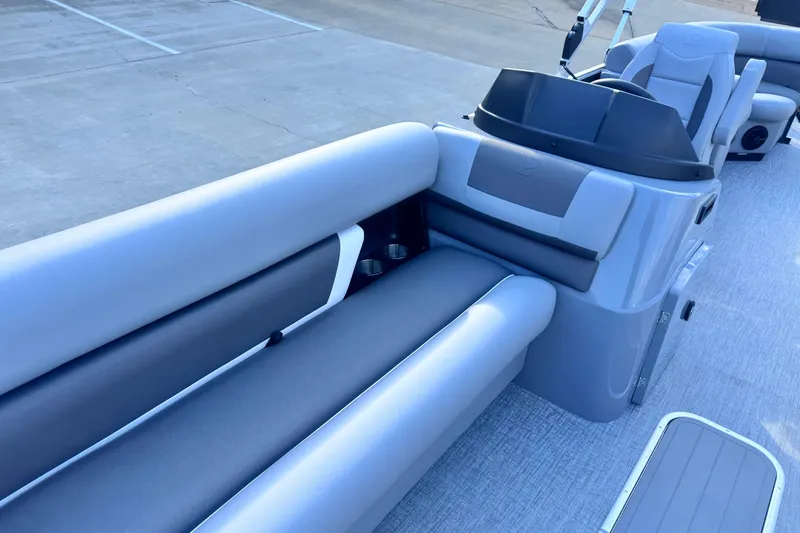 Slide: The Image of 2026 Landau Island Breeze 25 pontoon boat interior with gray seating and helm. - 11