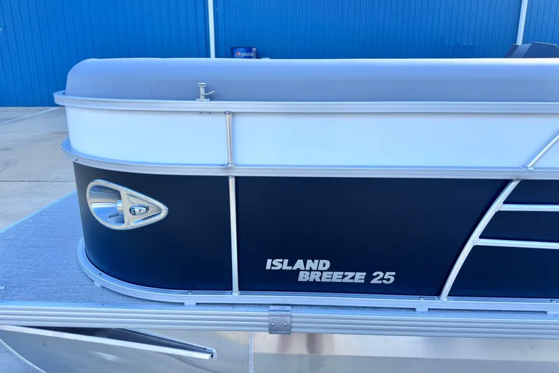 Slide: The Image of 2026 Landau Island Breeze 25 pontoon boat, sleek design, blue and white exterior. - 3