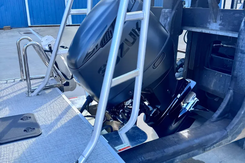 Slide: The Image of 2026 Landau Island Breeze 25 boat with Suzuki outboard motor and ladder. - 5