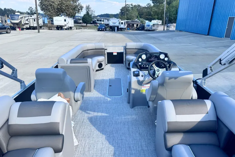 Slide: The Image of 2026 Landau Island Breeze 25 pontoon boat interior with plush seating and modern dashboard. - 8