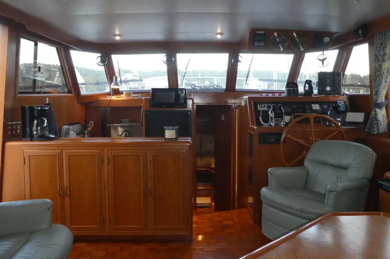 Slide: The Image of Interior of 1992 Ocean Alexander 456 Classicco yacht with wooden cabinetry and steering wheel. - 10