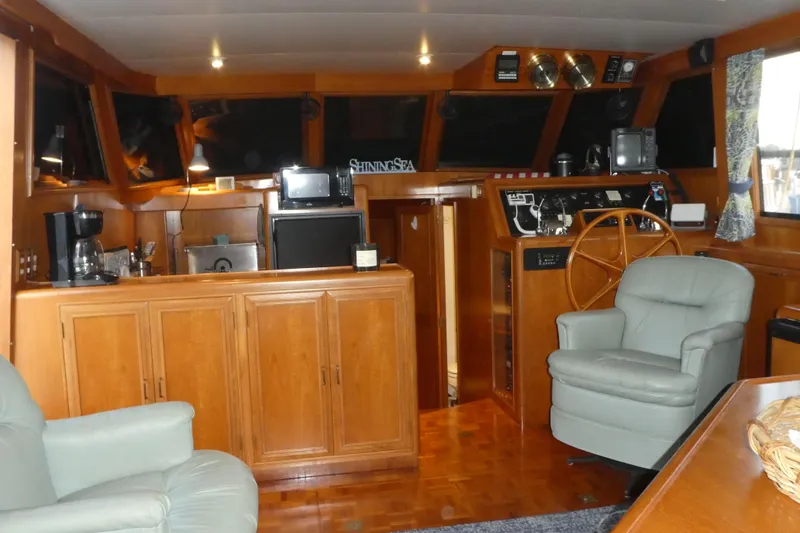 Slide: The Image of Luxurious 1992 Ocean Alexander 456 Classicco yacht interior with wood cabinetry and comfortable seating. - 11