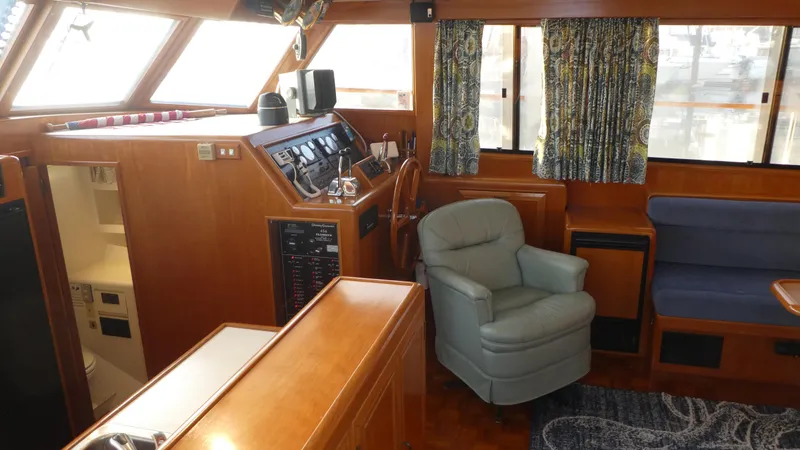 Slide: The Image of Interior of 1992 Ocean Alexander 456 Classicco yacht with helm, seating, and wood paneling. - 12