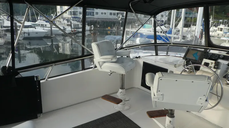 Slide: The Image of Interior view of 1992 Ocean Alexander 456 Classicco yacht helm with marina backdrop. - 38