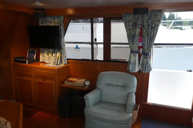 Slide: The Image of Interior of 1992 Ocean Alexander 456 Classicco yacht with armchair, TV, and wooden cabinetry. - 6