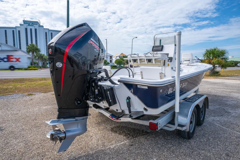 Slide: The Image of 2021 Blazer Bay 2200 boat with Mercury engine on trailer, parked near hotel. - 10