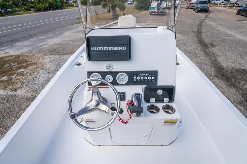 Slide: The Image of 2021 Blazer Bay 2200 boat console with steering wheel and Humminbird electronics. - 13