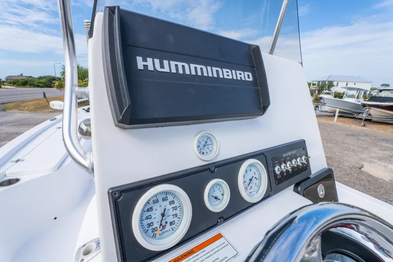 Slide: The Image of 2021 Blazer Bay 2200 boat dashboard with Humminbird display and gauges. - 14