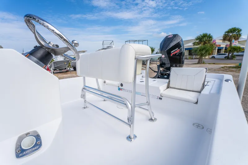 Slide: The Image of 2021 Blazer Bay 2200 boat interior with steering wheel and seating, showcasing modern design. - 16