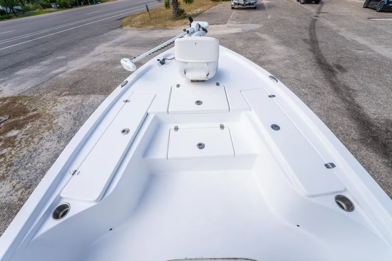 Slide: The Image of 2021 Blazer Bay 2200 boat deck with storage compartments and trolling motor. - 21