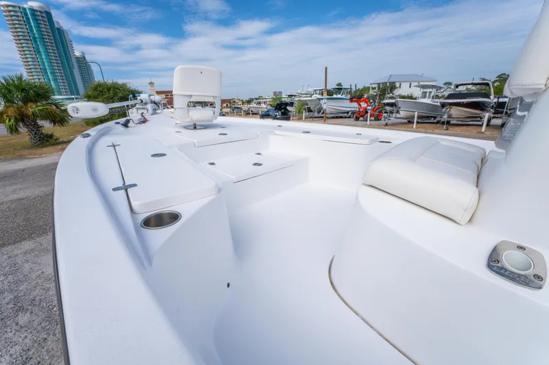 Slide: The Image of 2021 Blazer Bay 2200 boat interior with white seating and storage compartments. - 22