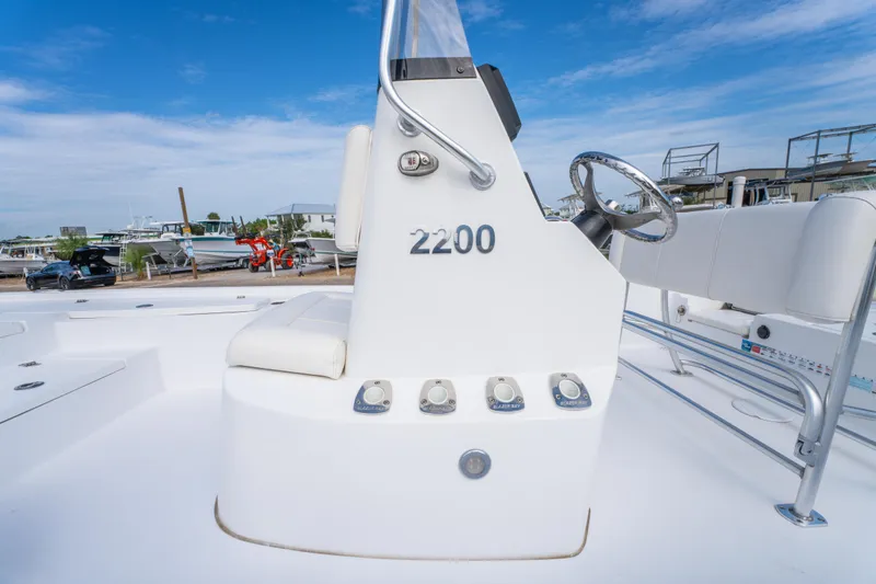 Slide: The Image of 2021 Blazer Bay 2200 boat console with steering wheel and controls. - 24