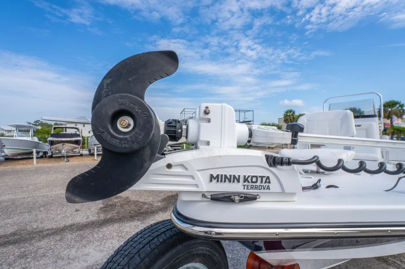 Slide: The Image of 2021 Blazer Bay 2200 boat with Minn Kota Terrova motor, parked outdoors under blue sky. - 27