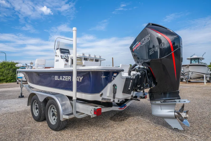 Slide: The Image of 2021 Blazer Bay 2200 boat with powerful outboard motor on trailer. - 5