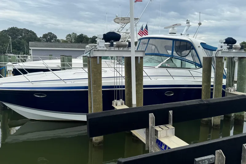 The Image of 2006 Formula 40 Performance Cruiser docked at marina with American flags. - 0