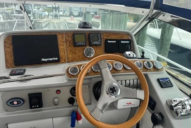 Slide: The Image of 2006 Formula 40 Performance Cruiser helm with Raymarine electronics and wooden steering wheel. - 9