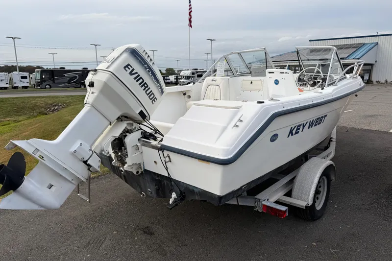 Slide: The Image of Key West 2020 Dual Console boat with Evinrude engine on trailer, side view. - 3