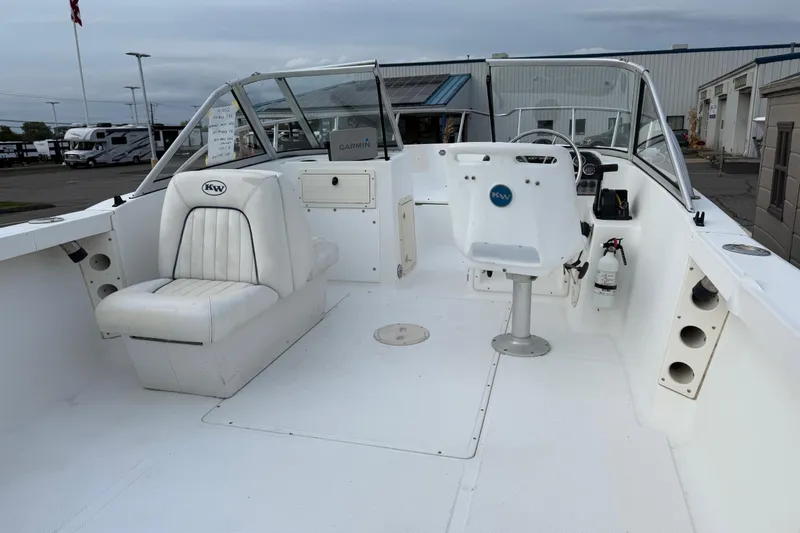 Slide: The Image of Key West 2020 Dual Console boat interior, white seating, steering wheel, and dashboard. - 4