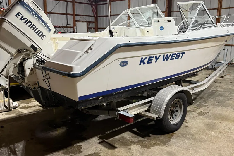 Slide: The Image of Key West 2020 Dual Console boat on trailer in a garage setting. - 6